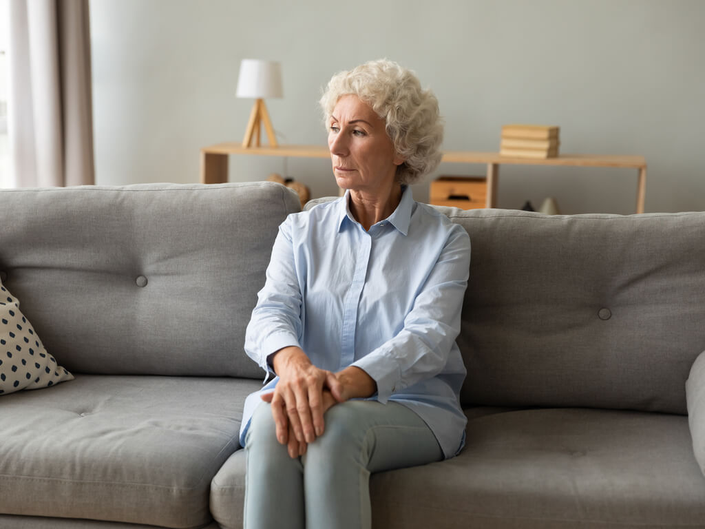 stern woman sitting on a couch